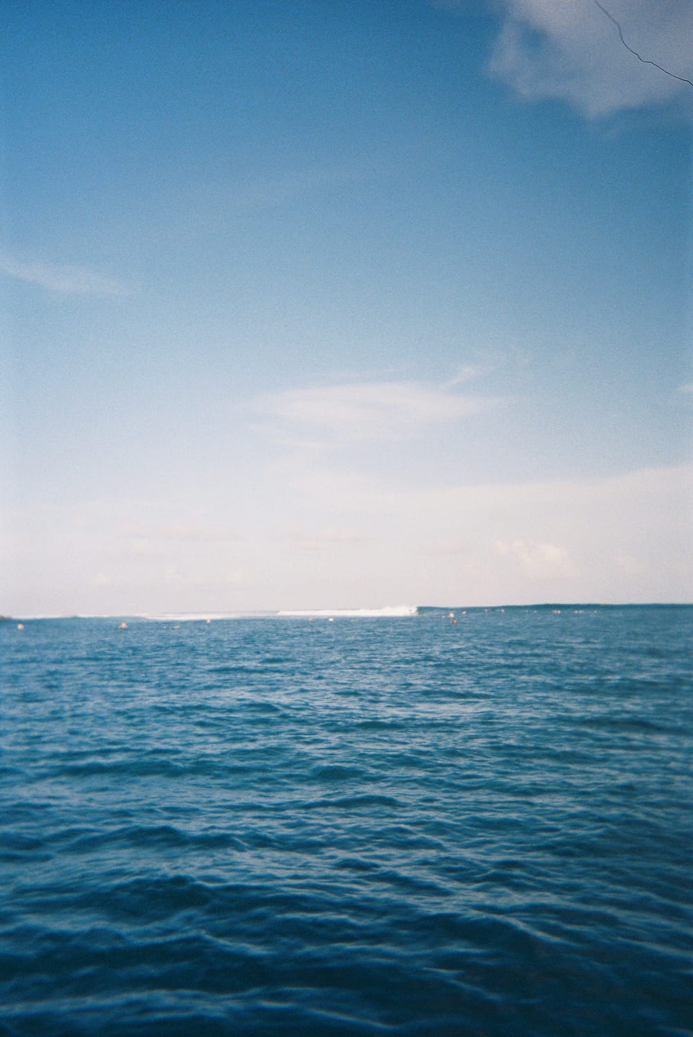 A breaking wave on a shallow reef under a clear sky